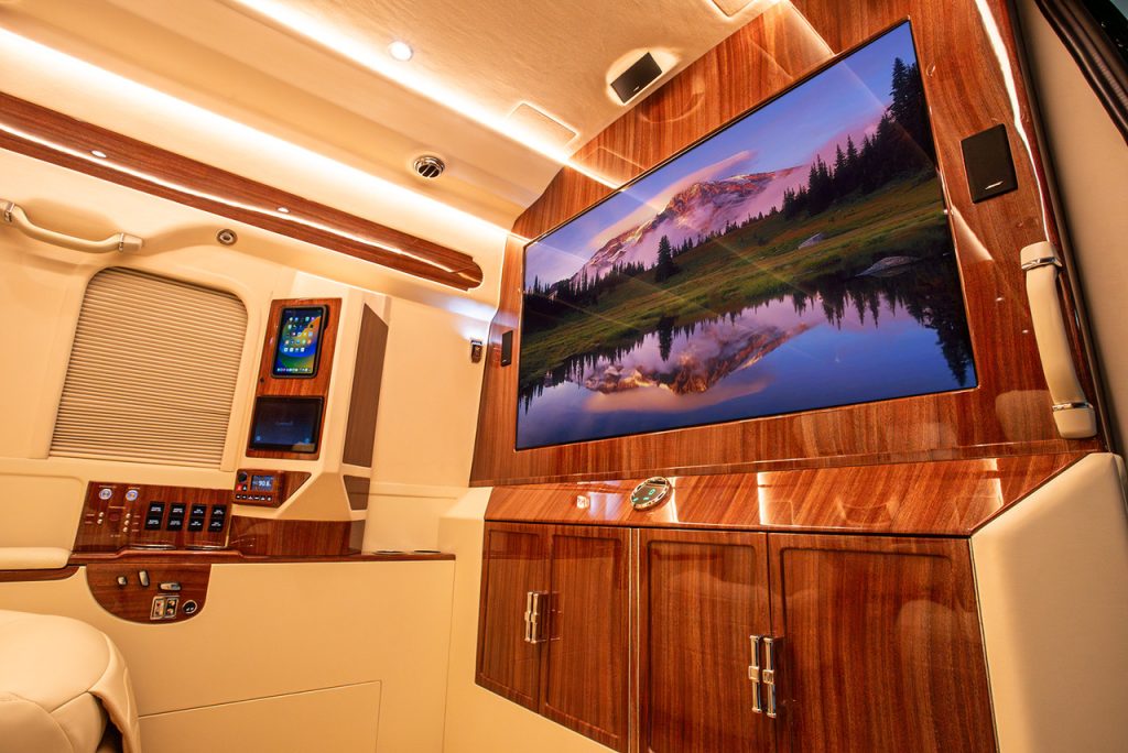 Luxury Sprinter interior with TV partition and lower bar area
